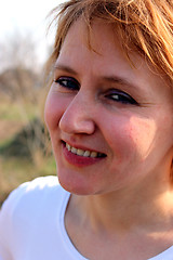 Image showing blue-eyed sympathetic girl looking at the sky