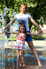 Image showing mother and daughter dancing in the fountains