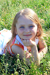 Image showing portrait of little girl lying on the grass