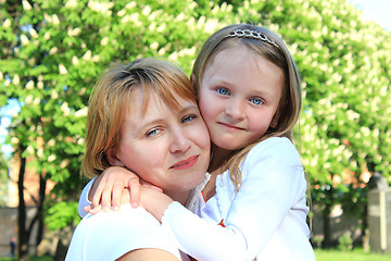 Image showing mother and daughter embrace one another