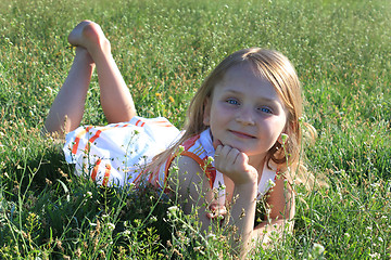 Image showing portrait of little girl lying on the grass