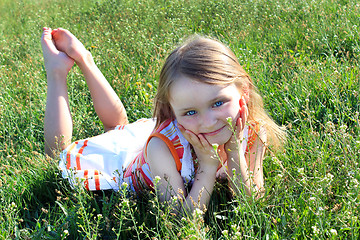 Image showing little girl lying on the grass