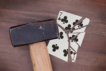 Image showing Hammer with a broken card, seven of clubs