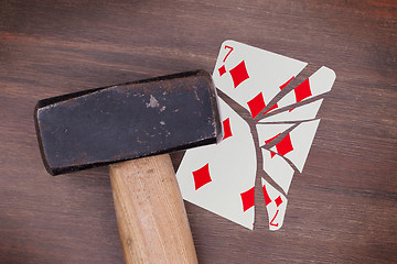 Image showing Hammer with a broken card, seven of diamonds