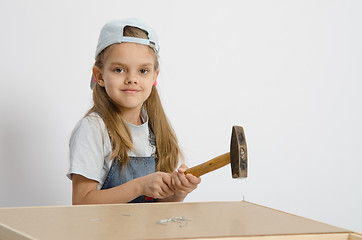 Image showing child hammer a nail into the back of chest