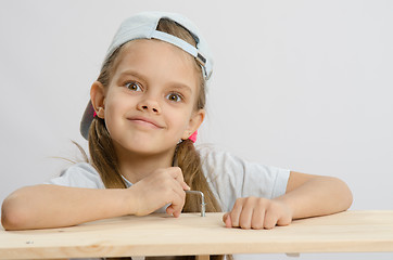 Image showing Girl likes to twist the screw with an Allen key