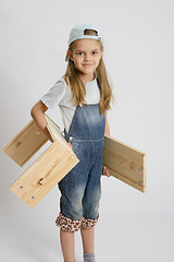Image showing Portrait of a six year old girl with boards in hands
