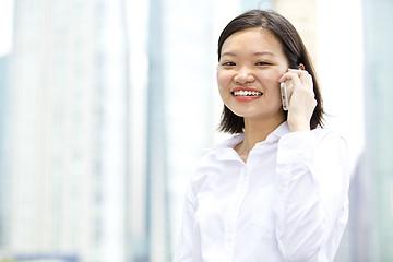 Image showing Asian young female executive talking on smart phone