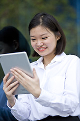 Image showing Asian young female executive using tablet