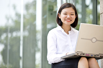 Image showing Asian young female executive using laptop