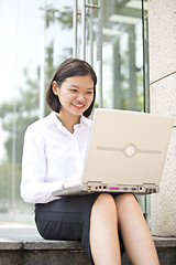 Image showing Asian young female executive using laptop