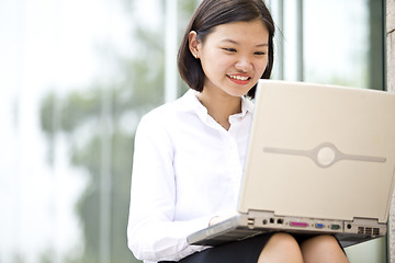 Image showing Asian young female executive using laptop