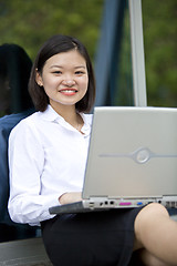 Image showing Asian young female executive using laptop