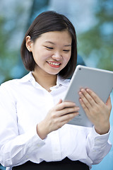 Image showing Asian young female executive using tablet