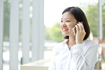 Image showing Asian young female executive talking on smart phone