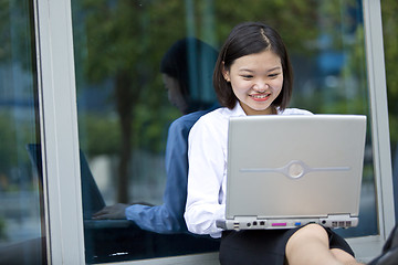 Image showing Asian young female executive using laptop