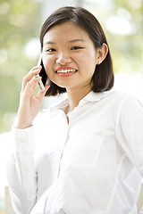 Image showing Asian young female executive talking on smart phone