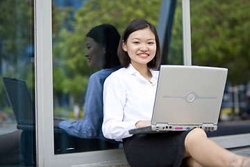 Image showing Asian young female executive using laptop