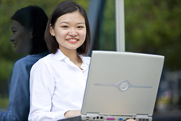 Image showing Asian young female executive using laptop