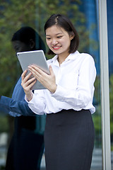 Image showing Asian young female executive using tablet