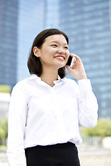 Image showing Asian young female executive talking on smart phone