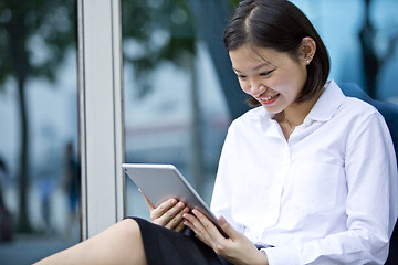 Image showing Asian young female executive using tablet