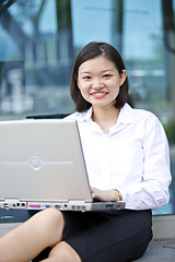 Image showing Asian young female executive using laptop