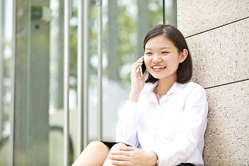 Image showing Asian young female executive talking on smart phone