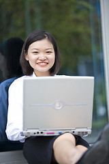 Image showing Asian young female executive using laptop