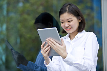 Image showing Asian young female executive using tablet