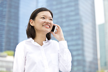 Image showing Asian young female executive talking on smart phone