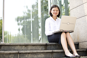 Image showing Asian young female executive using laptop