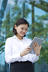 Image showing Asian young female executive using tablet