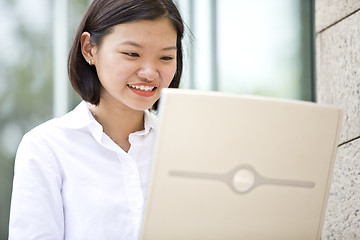 Image showing Asian young female executive using laptop