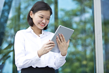 Image showing Asian young female executive using tablet