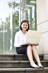 Image showing Asian young female executive using laptop