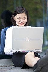 Image showing Asian young female executive using laptop