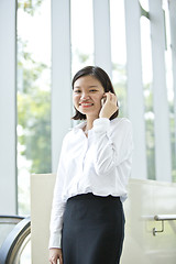 Image showing Asian young female executive talking on smart phone