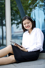 Image showing Asian young female executive using tablet