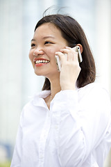 Image showing Asian young female executive talking on smart phone