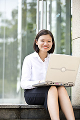 Image showing Asian young female executive using laptop