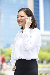 Image showing Asian young female executive talking on smart phone