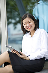 Image showing Asian young female executive using tablet