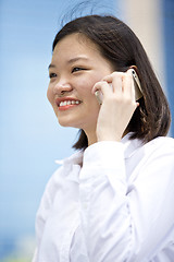 Image showing Asian young female executive talking on smart phone