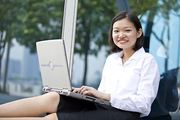 Image showing Asian young female executive using laptop