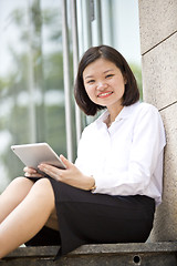 Image showing Asian young female executive using tablet