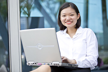 Image showing Asian young female executive using laptop