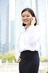 Image showing Asian young female executive talking on smart phone