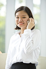 Image showing Asian young female executive talking on smart phone