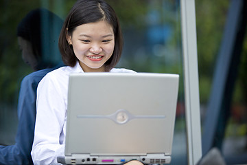 Image showing Asian young female executive using laptop